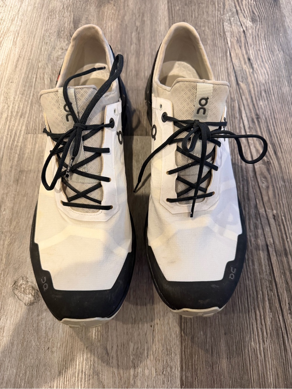 On Running Women’s Low-Top Trail Running Athletic Sneakers in White and Black